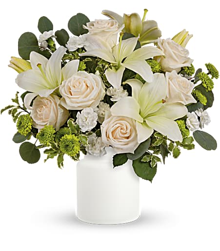 White lilies and cream roses in a white vase