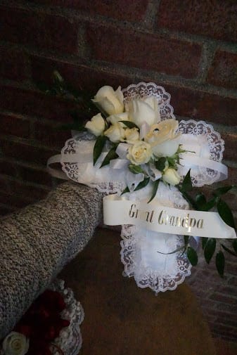 White rose bouquet with lace trim and a ribbon reading "Buon Giorno"