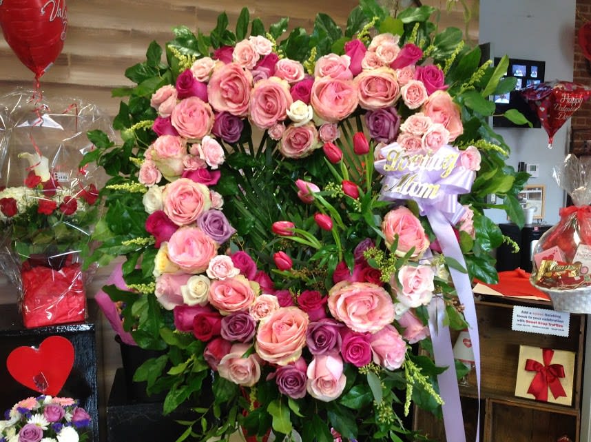 Large heart-shaped rose wreath with a lavender ribbon reading Loving Mom