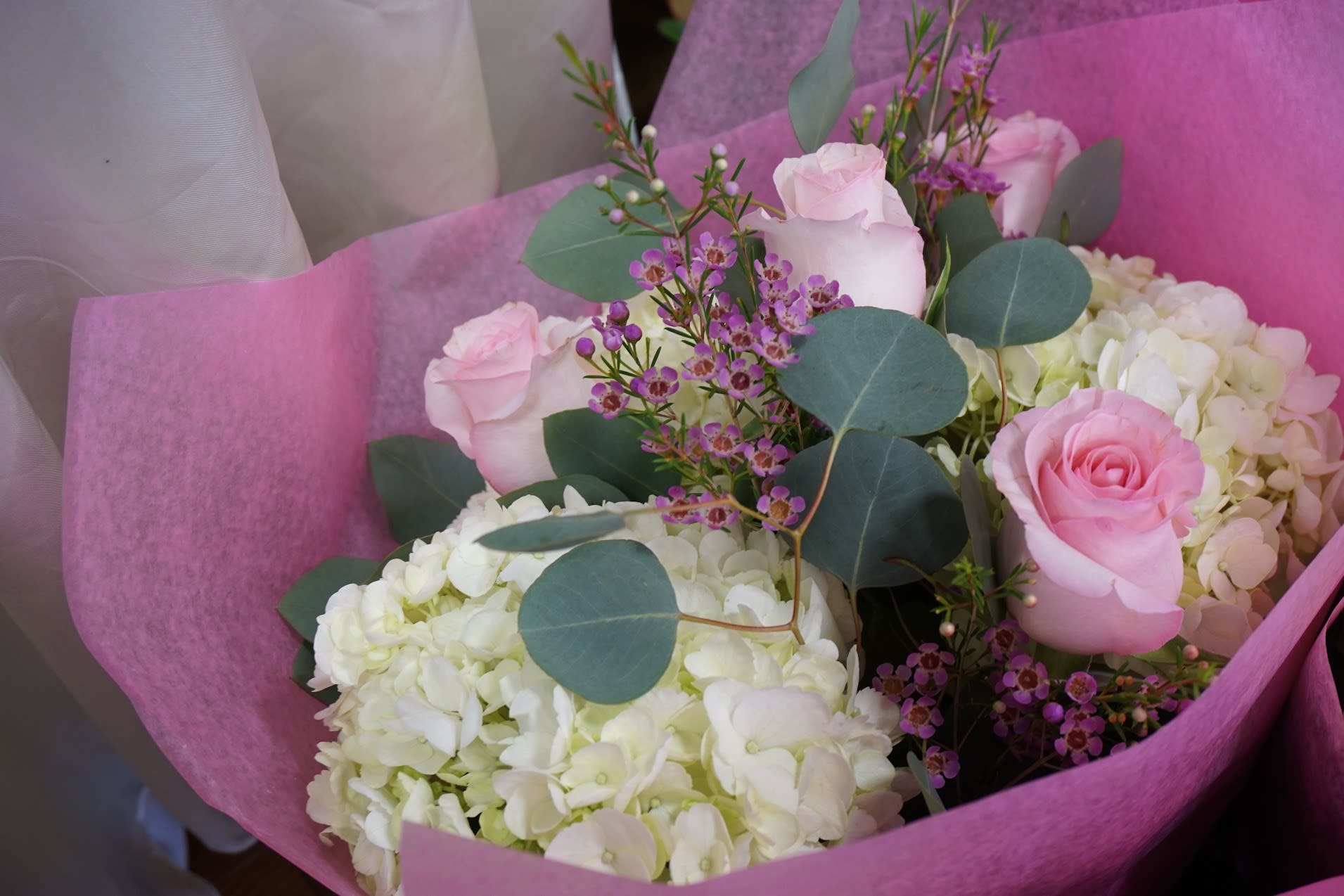 Pink roses and white hydrangeas in pink wrapping