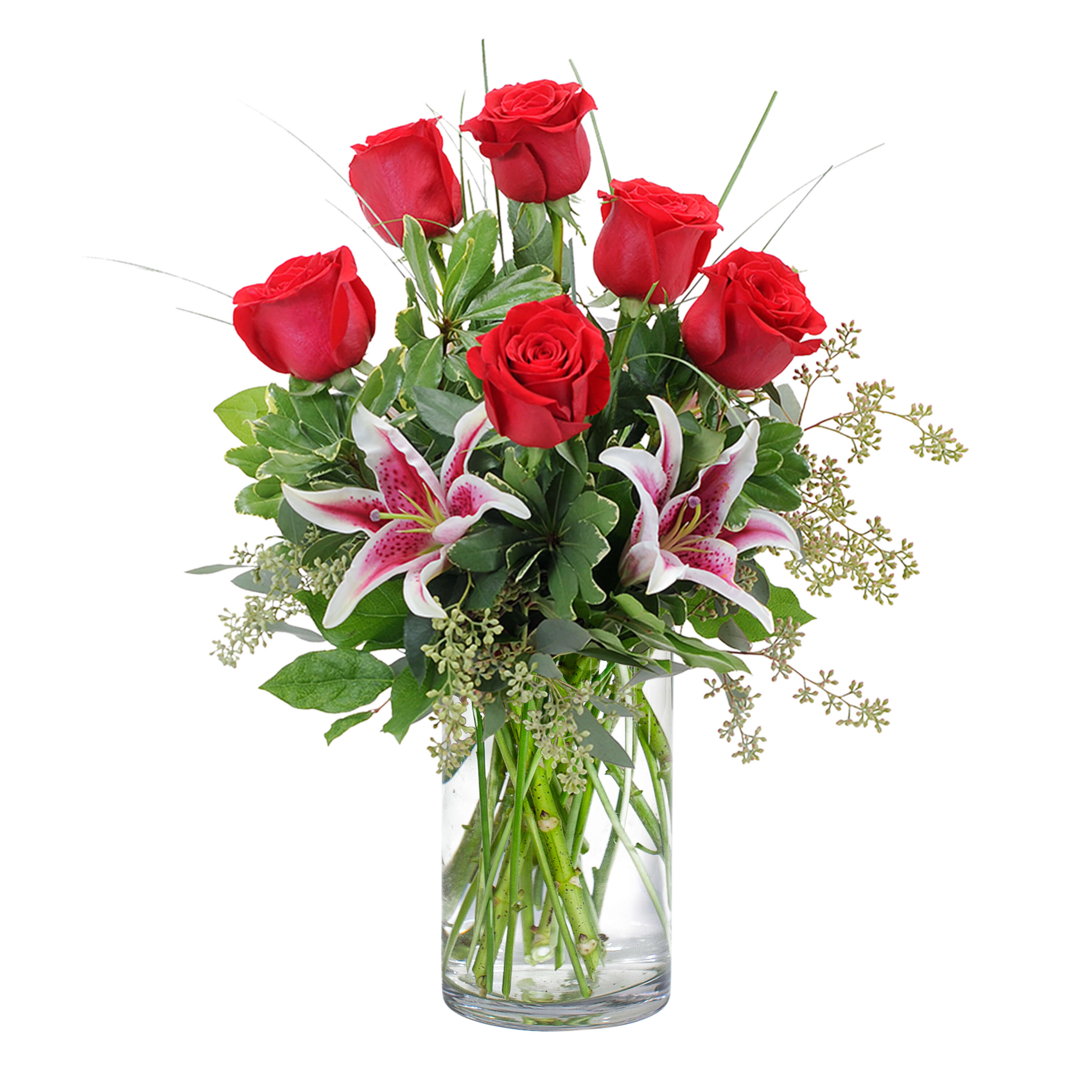 Red roses and pink lilies in a clear glass vase