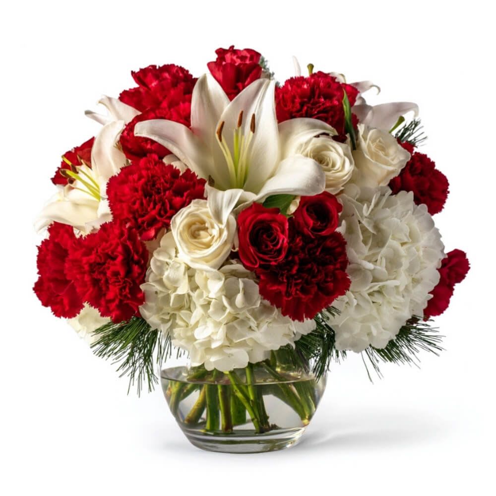 Red and white flower arrangement in a glass vase