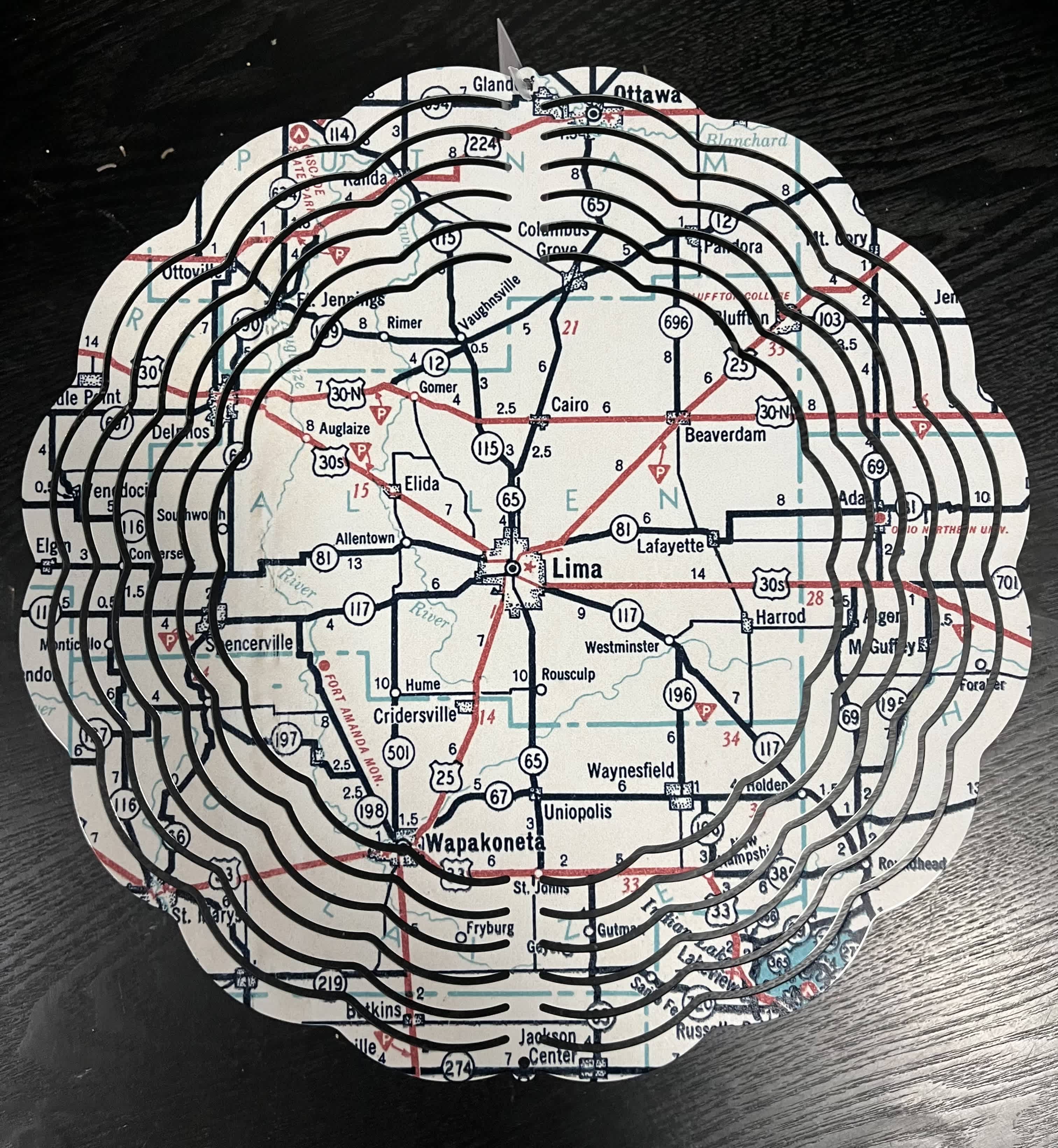 Round map-cutout decorative piece with layered black rings