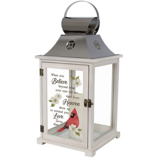 Decorative white lantern with a cardinal and memorial text on the glass