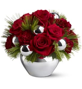 Silver Bells - Silver bells, silver bells, it's Christmas time in the city, the country or anywhere you might choose to be for the holidays. This stylish mix of red roses, carnations and silver ornaments in a silvery vase is the ultimate in urban chic.  Red roses and burgundy carnations – accented with evergreens and silver ornament balls – are delivered in a silver-toned jardiniere.  Approximately 11" (W) x 8.5" (H)  Orientation: All-Around  As Shown : TFWEB262
