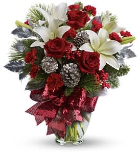 Holiday Enchantment Bouquet - Take your holiday gift-giving to new heights with this dramatic bouquet! Classic red roses, snowy lilies and naturally festive berries and pine are gathered in a tall arrangement they'll long remember.  A lavish arrangement of red roses, white asiatic lilies, red carnations, noble fir, white pine, red berries, accented with silver pinecones and leaves. Finished with a rich red ribbon, this bouquet is dressed in holiday style.  Approximately 17" W x 19" H  Orientation: One-Sided  As Shown : TWR07-1A Deluxe : TWR07-1B Premium : TWR07-1C