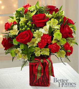 The FTD® Yuletide Joys Holiday Bouquet by Better Homes and Gardens®  - Picked fresh from the farm to give your special recipient a holiday bouquet that looks like it's straight out of a magazine, The Better Homes and Gardens® Yuletide Joys Holiday Bouquet creates that perfect Christmas gift. Hand gathered at select floral farms and bringing together the brightest greens and richest reds of the season, this gorgeous Christmas bouquet has been picked fresh for you to send your warmest season's greetings to friends and family throughout the holiday months ahead. Bouquet includes: red roses, burgundy mini carnations, green Peruvian Lilies, green button poms, green hypericum berries, and lush holiday greens. Presented with a red glass vase tied with a green and red plaid ribbon. BETTER bouquet is approximately 15" H x 14" W  Your purchase includes a complimentary personalized gift message.