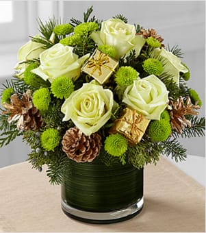 The FTD® Seasons Sparkle™ Bouquet - The FTD® Season's Sparkle™ Bouquet brings an elegance and sophistication to the holiday season with it's natural elements and style. Jade green roses are stunning surrounded by green button poms, assorted holiday greens, gold tipped pinecones and gold present pics to create an impressive fresh flower arrangement. Presented in a clear glass cylinder vase lined with ti green leaf material to give it a polished finish, this holiday flower bouquet is set to make the perfect impression on any of the special people on your Christmas gift list. BETTER bouquet is approximately 11"H x 12"W. Your purchase includes a complimentary personalized gift message.