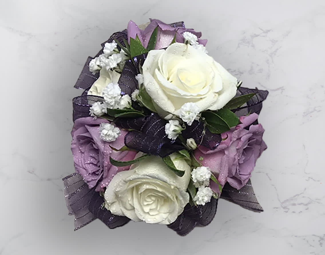 Bouquet of white and lavender roses with dark ribbon accents