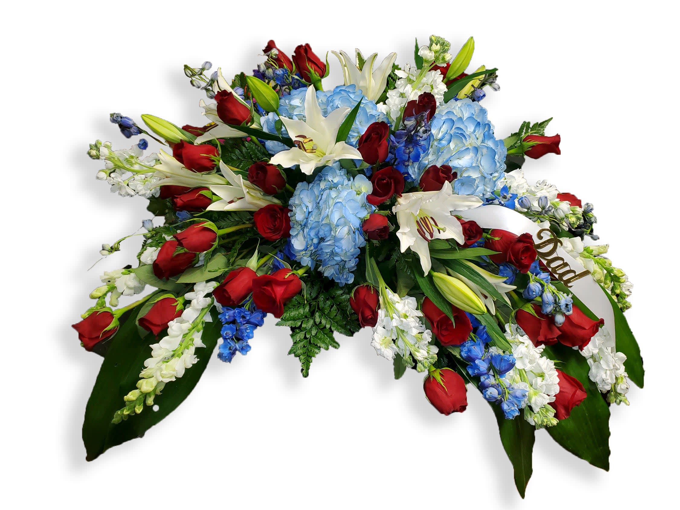 Casket spray with red roses, blue hydrangeas, and white lilies