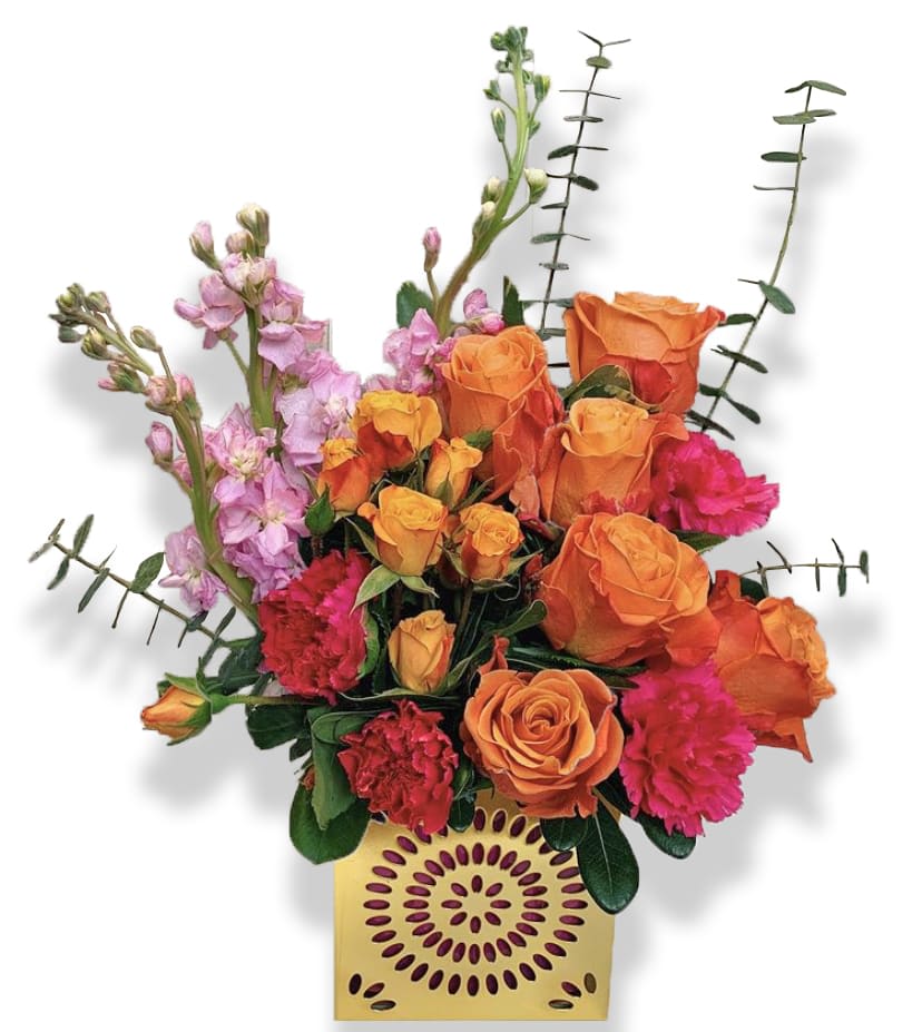 Orange roses and pink flowers in a decorative yellow vase