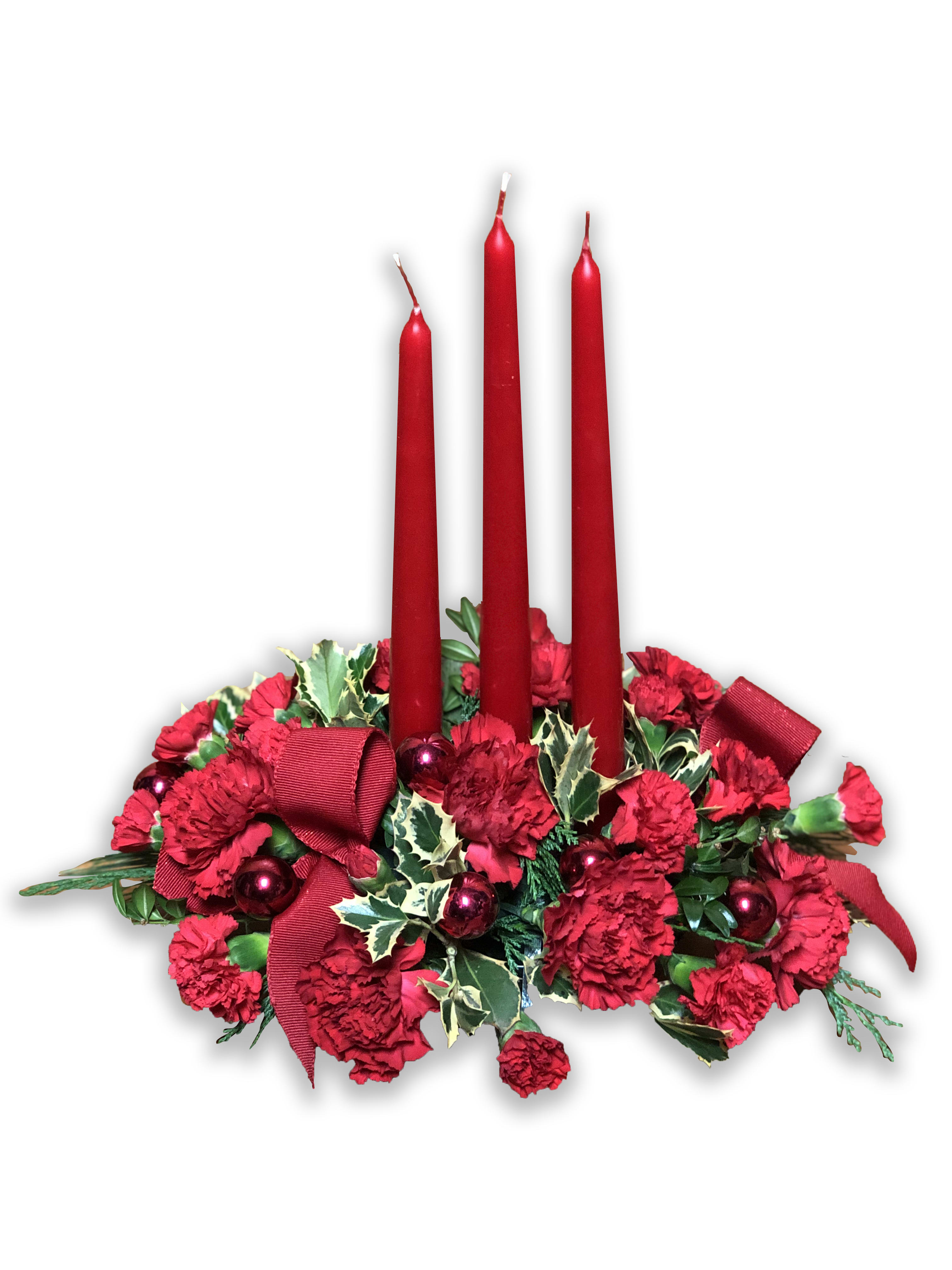 The FTD® Lights of the Season™ Centerpiece - The FTD® Lights of the Season™ Centerpiece is an exquisite way to bring the magic of the holiday season to your celebrations with family and friends. Brilliant red carnations and mini carnations are gorgeously arranged amongst variegated holly and an assortment of holiday greens. Accented with red glass balls and a bright red wired ribbon, this arrangement encircles 3 red taper candles to bring the perfect glow to your festivities. 