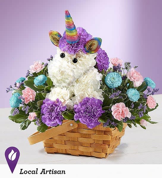 Unicorn-shaped floral arrangement in a basket with purple, pink, and blue flowers