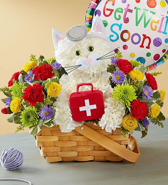 Basket of colorful flowers with a cat-shaped plush and a get well soon balloon