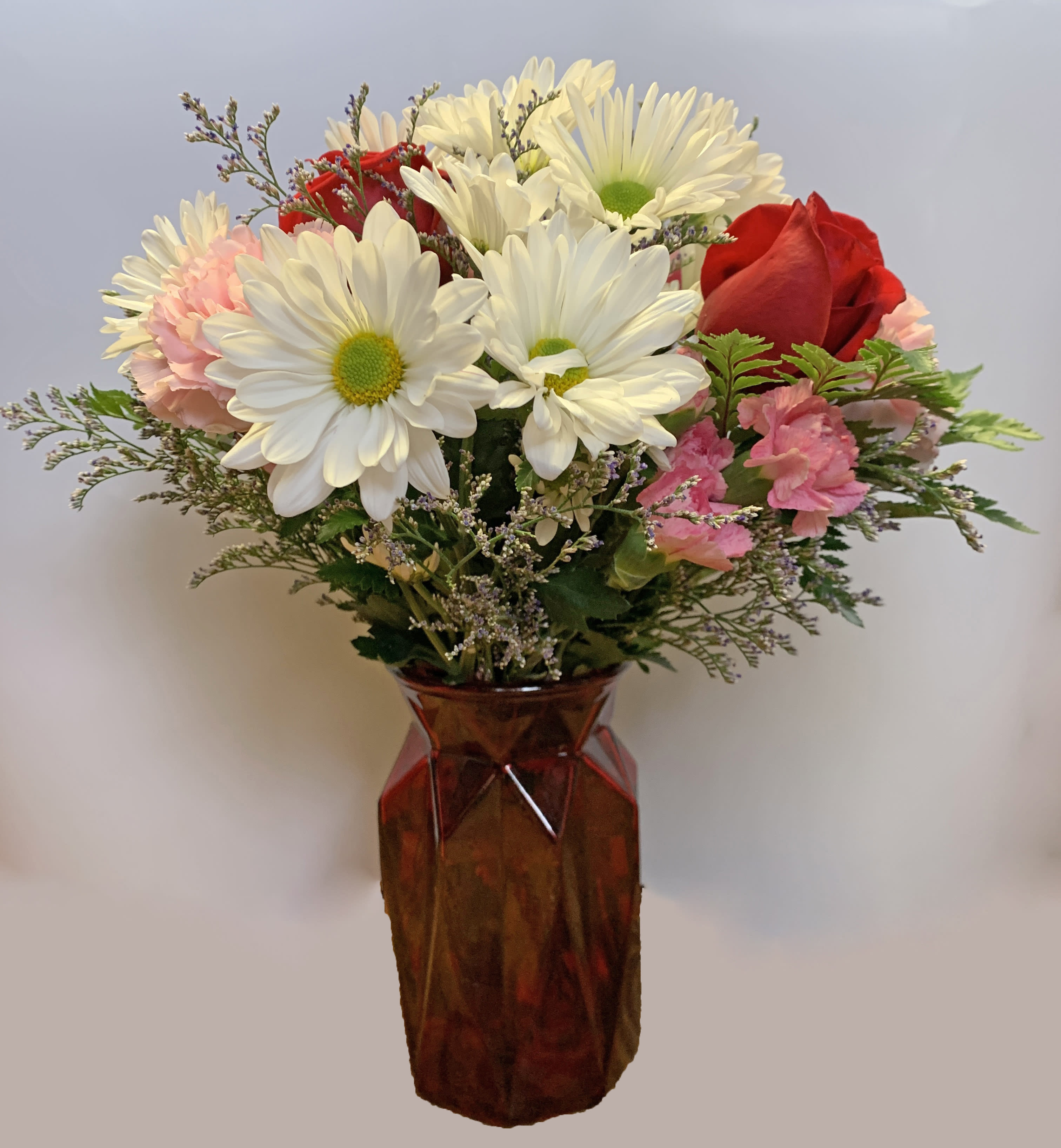 Boldly Bashful by BloomNation™ - This bouquet is a sweet way to show someone you care. Boldly Bashful by BloomNation™ is a great gift for Valentine's Day or Birthday.   Arrangement Details: Includes white chrystanthemum spray daisies, pink carnations, and red roses.  APPROXIMATE DIMENSIONS: 12" H X 10" W