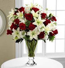 The FTD® Grand Occasion™ Bouquet by Vera Wang - The FTD® Grand Occasion™ Bouquet by Vera Wang is the perfect way to add sophistication and elegance into any celebration. Rich red roses collide with white stock and brilliant white Asiatic Lilies, accented with lush greens. Arranged in a clear glass vase with a gleaming metallic silver pedestal, this bouquet turns an ordinary day into an occasion of its own. BETTER bouquet includes 28 stems. Approximately 25"H x 21"W. Your purchase includes a complimentary personalized gift message.  Container is discontinued, we will sub a similar container