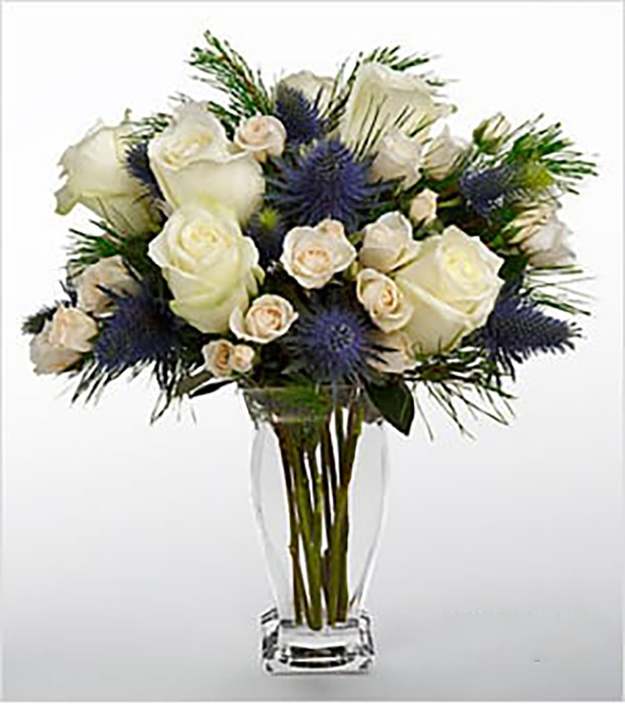 Vera Wang Winter Wonderland Bouquet - FTD® proudly presents the Vera Wang Winter Wonderland Bouquet. This fresh flower bouquet is set to send your heartfelt sentiments to your special recipient during this holiday season. Magnificent at every angle, this flower arrangement brings together fresh from the farm white roses, white spray roses and accents of Alpine thistle and pine. Presented in a superior glass vase meant to dazzle and delight your recipient for years to come, this Vera Wang fresh flower bouquet will make an extraordinary holiday, birthday, engagement, anniversary, or thank you gift. Bouquet includes 10 stems. Approximately 16"H x 14"W. Your purchase includes a complimentary personalized gift message.