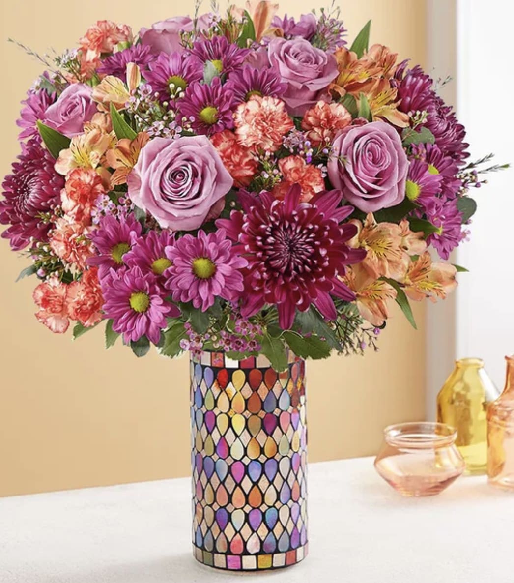 Bouquet of pink and purple flowers in a patterned vase
