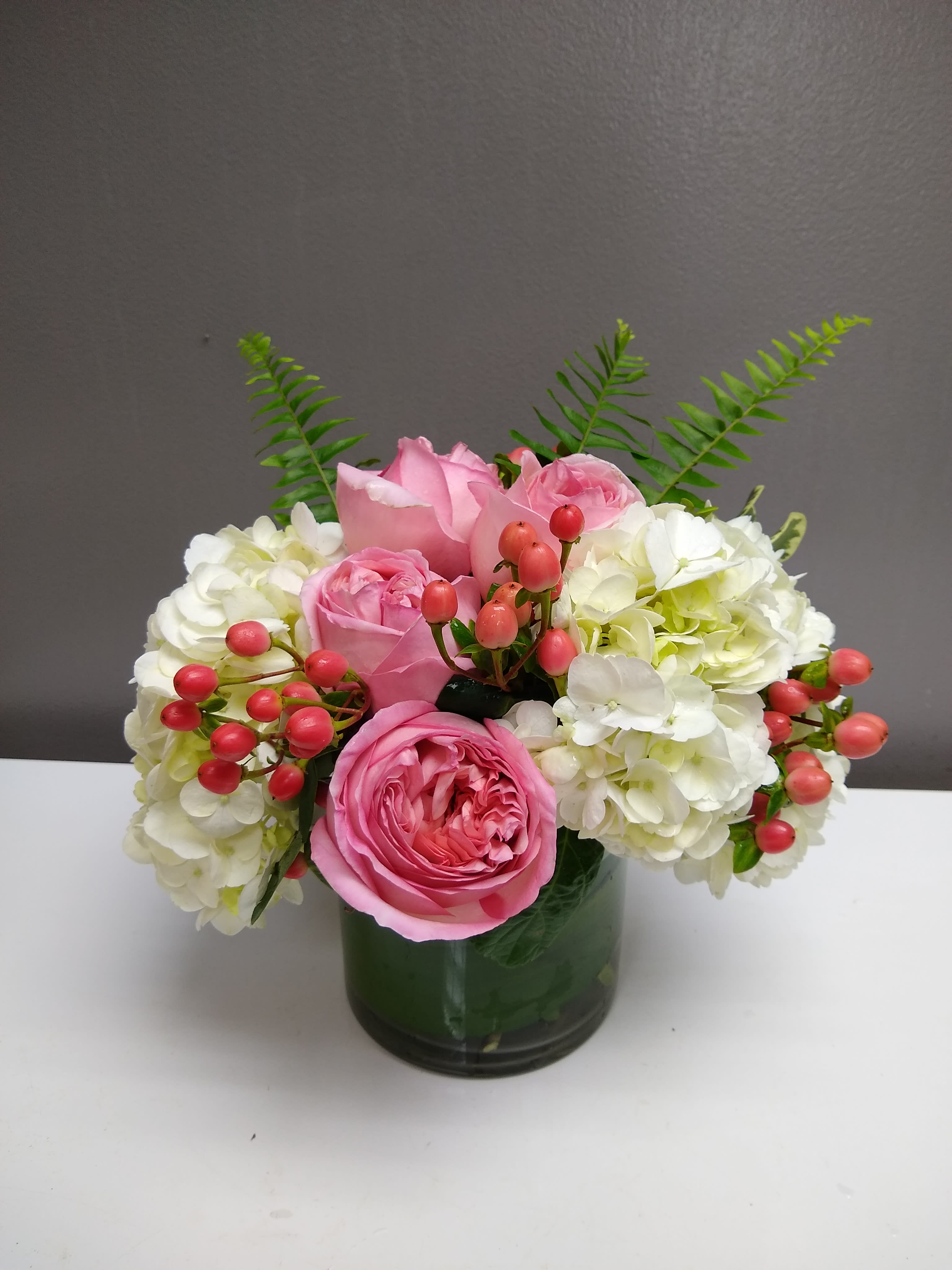 Precious Pinks - If you need a glamorous gift, look no further than this precious pink bouquet of upscale blooms such as roses, hydrangea and more, beautifully arranged in a glass cylinder. It’s a fine floral gift with a contemporary flair.