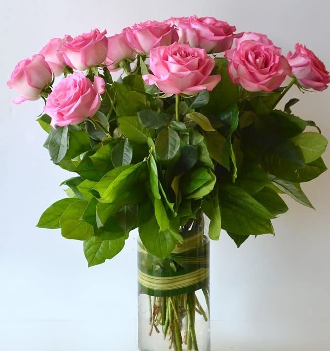 Pink roses arranged in a clear glass vase