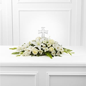  The FTD® Eternal Light™ Bouquet  - The FTD® Eternal Light™ Bouquet is an exquisite arrangement that honors the life of the deceased with each snowy white bloom. A beautiful cross is surrounded by white roses, gladiolus, Peruvian Lilies, Oriental Lilies, vibrant Boston Fern Fronds and lush greens to create a wonderful memorial arrangement for their final farewell service.   SKU#: ELB