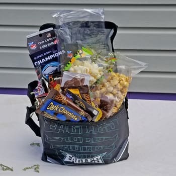 Gift basket with snacks and candy in an Eagles tote bag