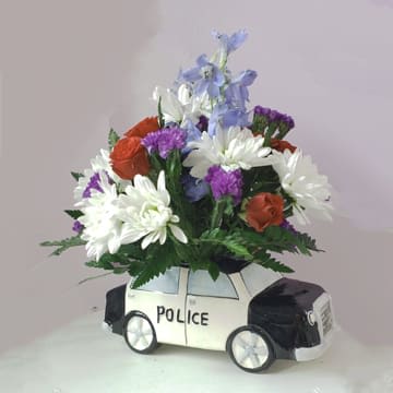 Flower arrangement in a police car-shaped container