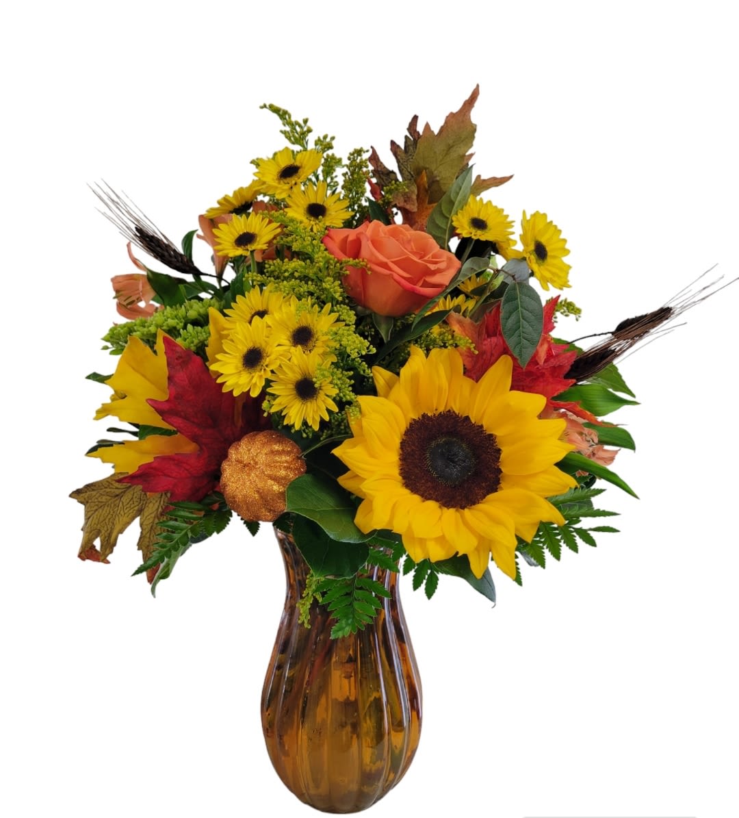 October Vibes - The perfect pick for the Autumn season, standing around 22" high by 16"wide. Flowers such as Sunflowers, Roses, Mums, Hydrangea and alstromeria accented with a faux pumpkin, fall leaves and wheat. This arrangement is designed in a an orange or burnt orange glass colored vase.