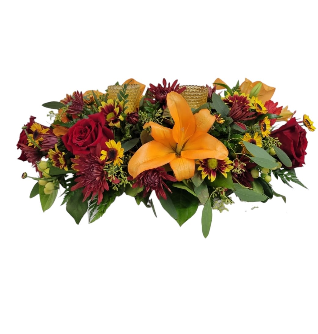 Fall Votive Centerpiece - A fall oval designed centerpiece with two candle votives. Flowers consisting of lilies, roses, hypericum berries, mums and daises. Perfect for a dinner party or holiday gathering!