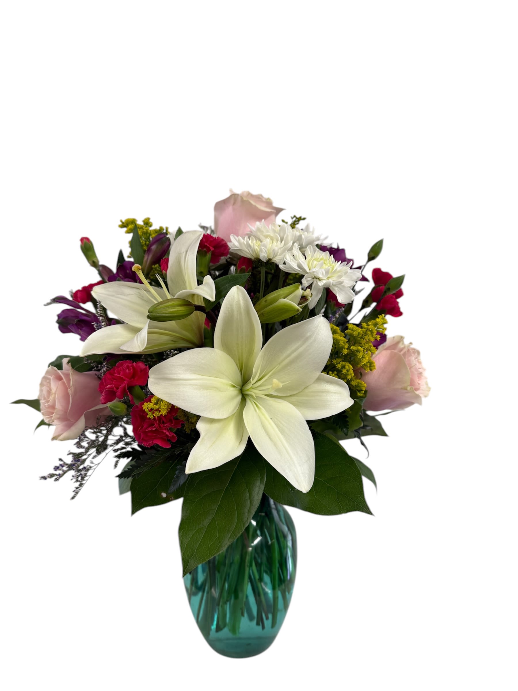 Bouquet of white lilies, pink roses, and mixed blooms in a blue glass vase