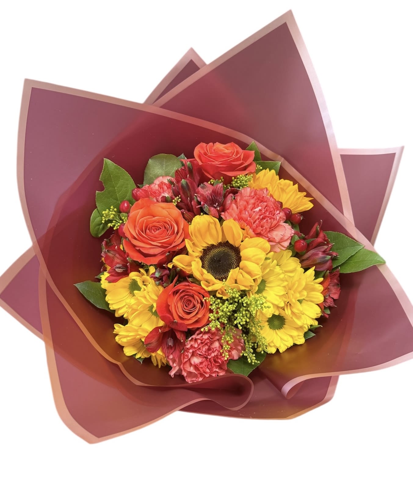 Bouquet of yellow daisies, orange roses, and pink carnations wrapped in burgundy paper
