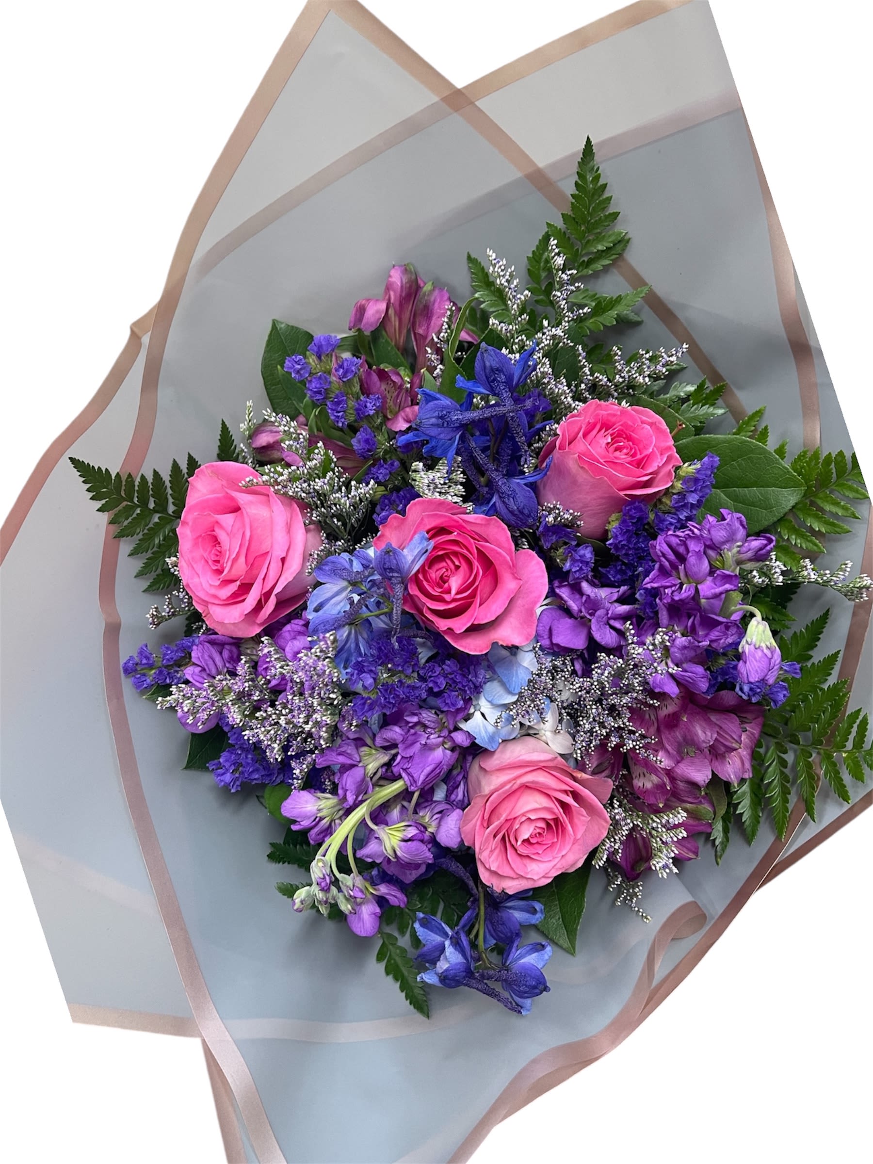 Bouquet of pink roses and purple flowers wrapped in translucent paper