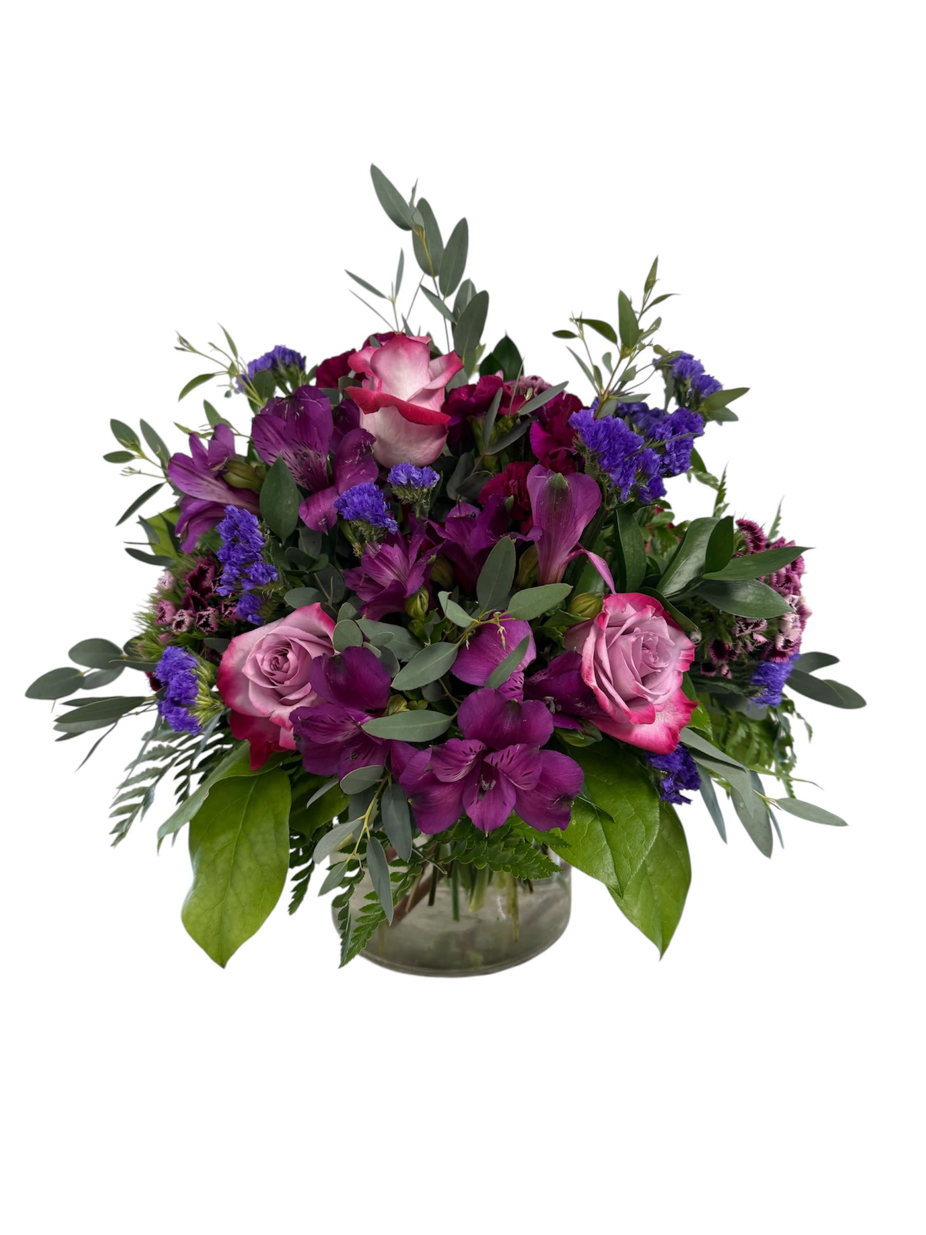 Purple and pink rose bouquet in a glass vase