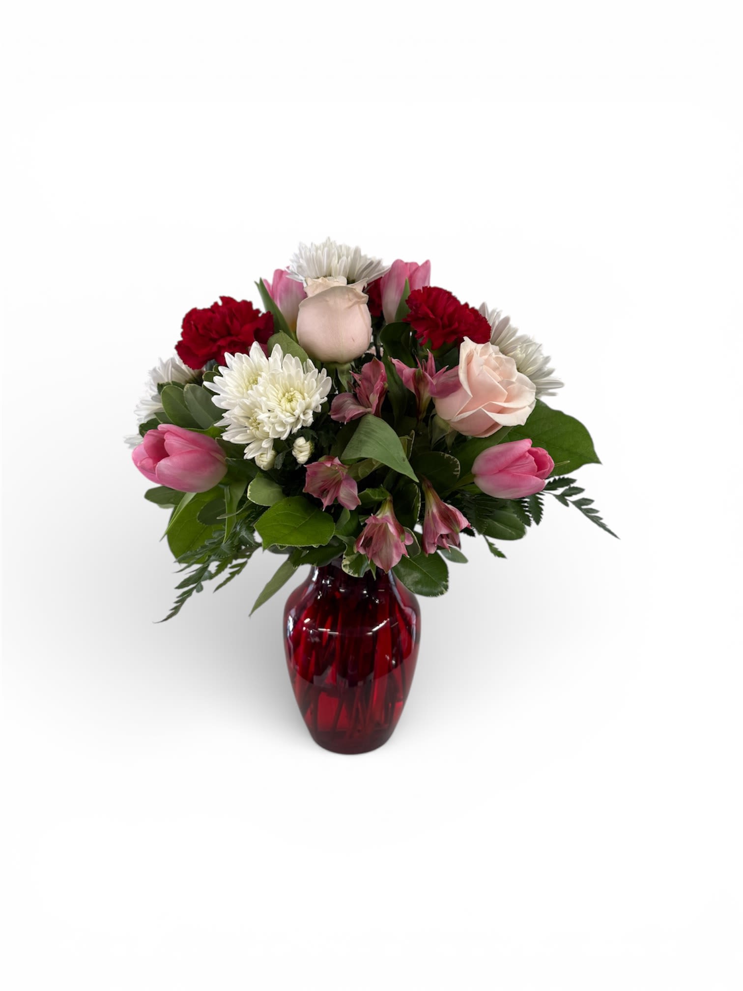 Mixed bouquet in a red glass vase with pink, white, and red blooms