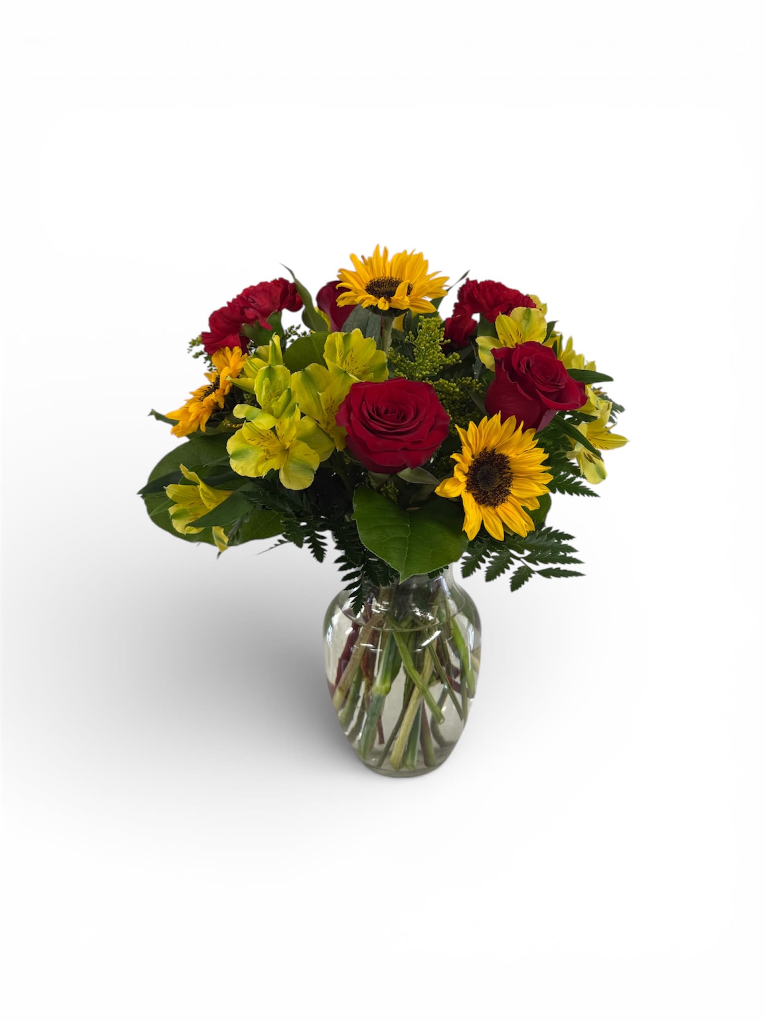 Bouquet of red roses and yellow sunflowers in a glass vase