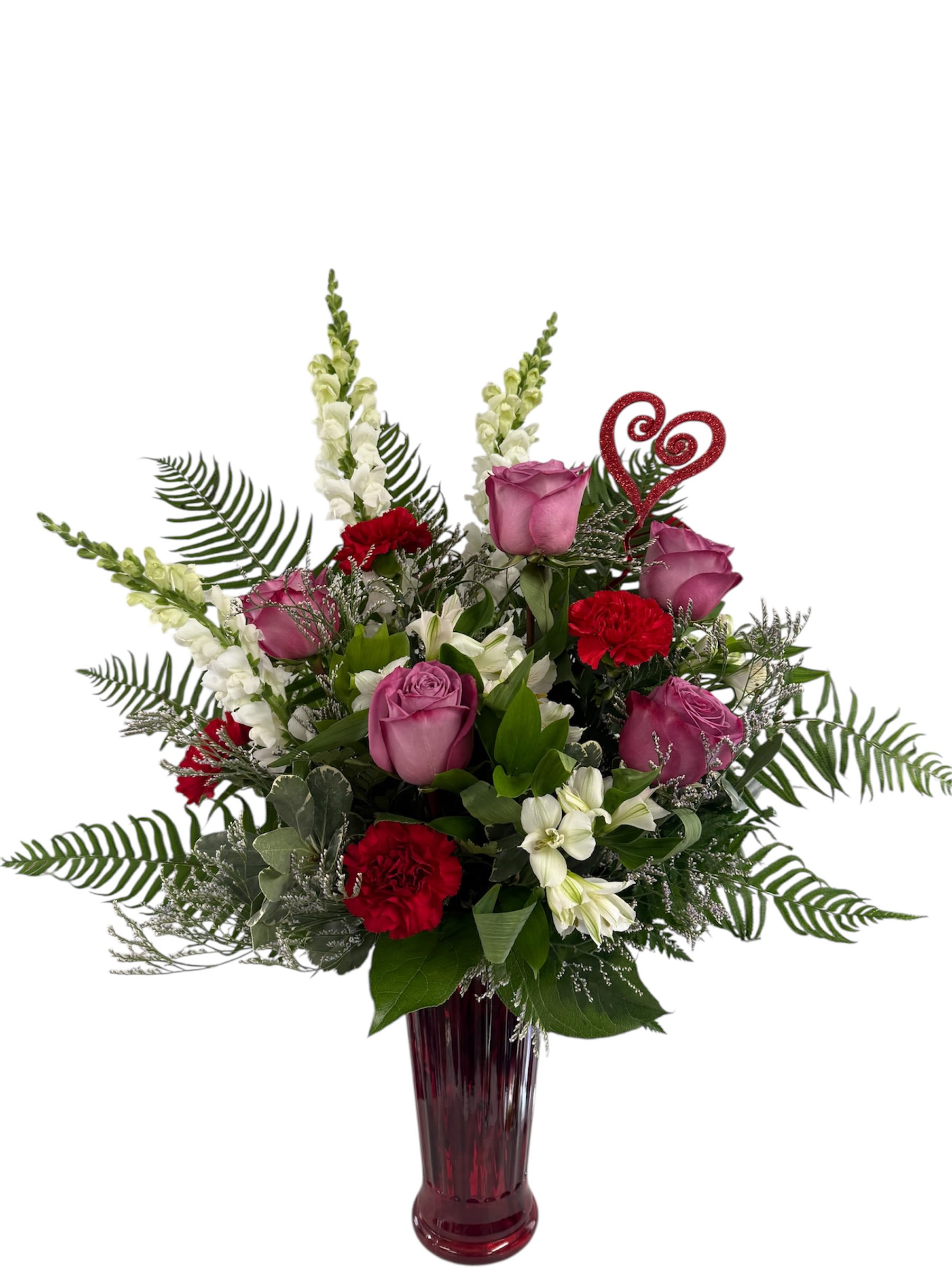 Pink roses and red carnations in a tall burgundy vase with a glitter heart pick