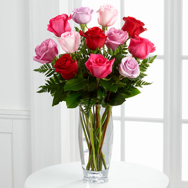 Bouquet of pink and red roses in a clear glass vase