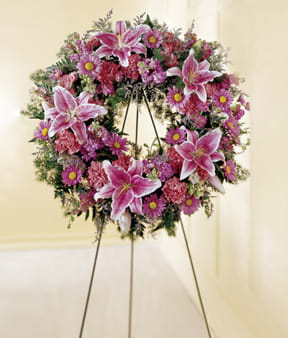 Pink and purple funeral wreath on a standing easel
