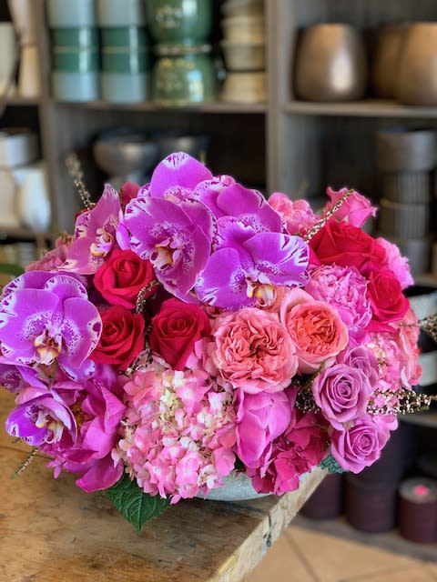 Royal Love - A stunning, lush arrangement artfully designed in a beautiful ceramic vase, featuring a harmonious blend of roses, spray roses, hydrangeas, and vibrant orchids (colors may vary depending on availability). This exquisite mix offers a touch of elegance and charm, perfect for any occasion.