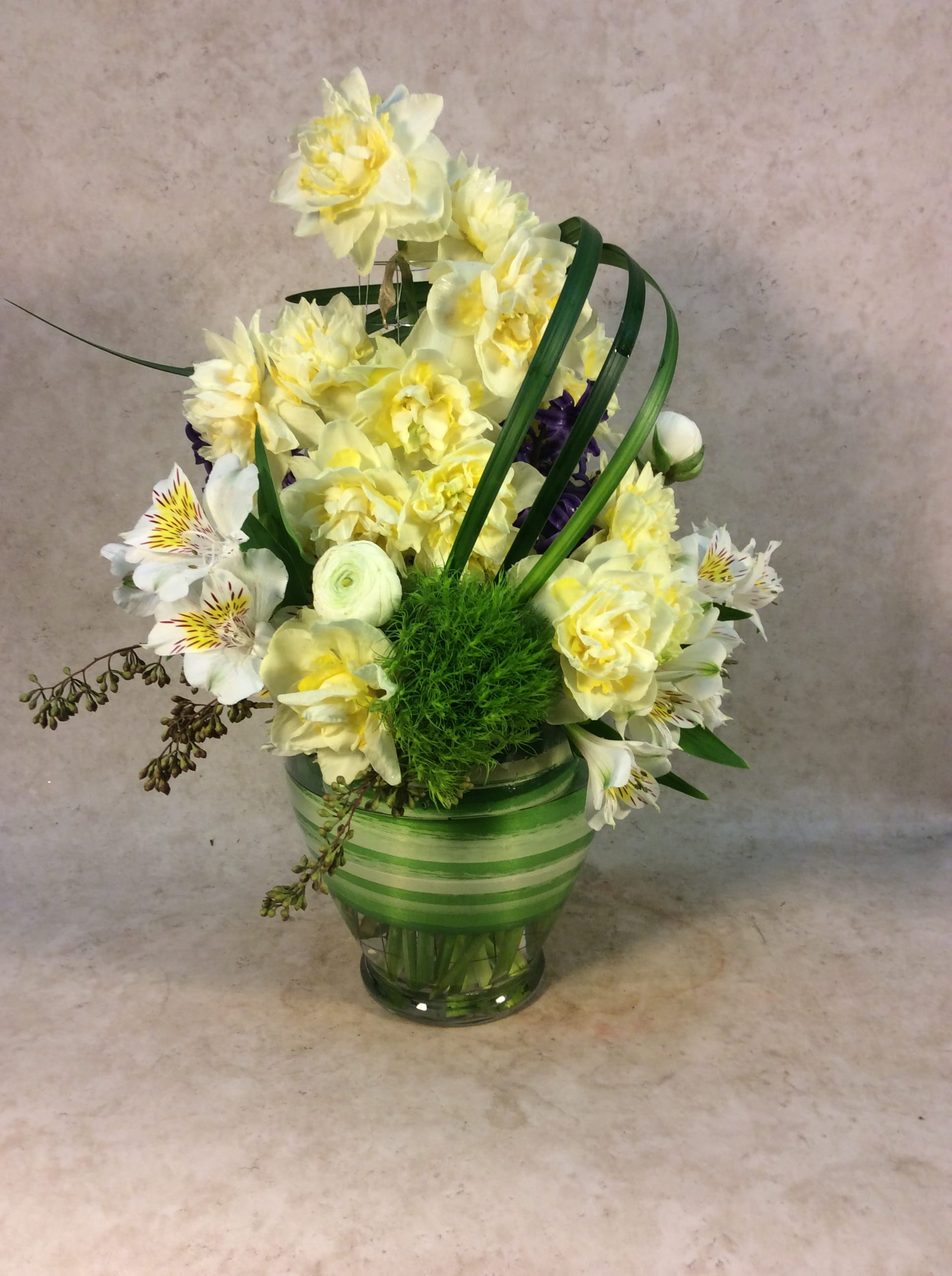 Spring Sunshine by W/E Flowers - A vase of sunshine and smiles. Here we have Yellow double stuffed Daffodils that are available the Month of April. Other months we will use Tulips, alstroemeria, gerbera daisy, snap dragons, lilies or roses in a bright Yellow!