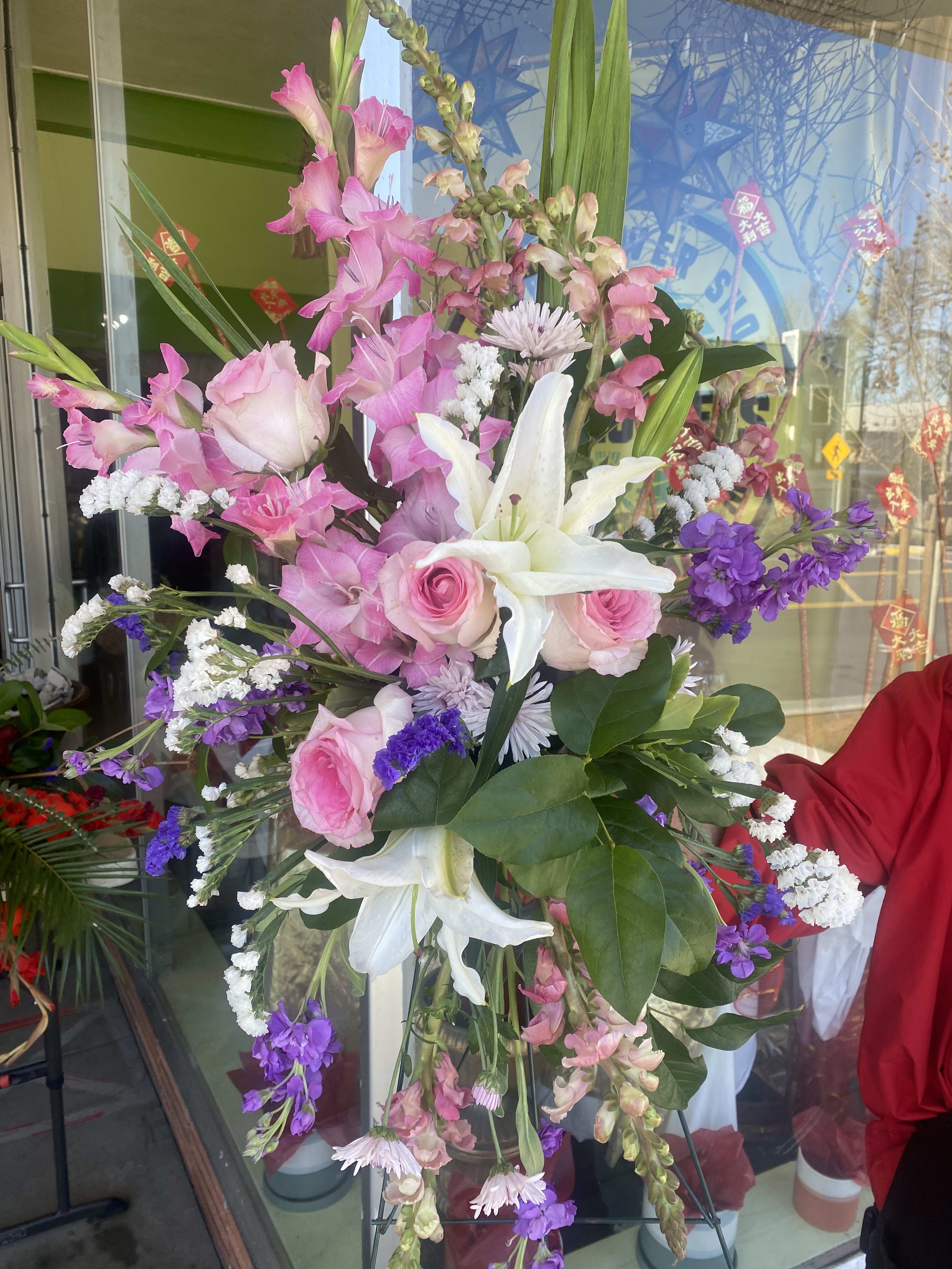 Tall mixed bouquet with pink roses, white lilies, and purple flowers