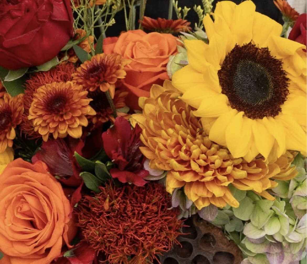 Bouquet of sunflowers, roses, and orange chrysanthemums