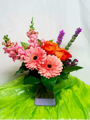 Pink gerbera daisies and orange roses in a vase