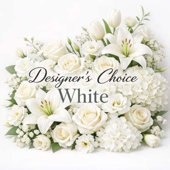 White roses, lilies, and hydrangeas arranged in a low bouquet