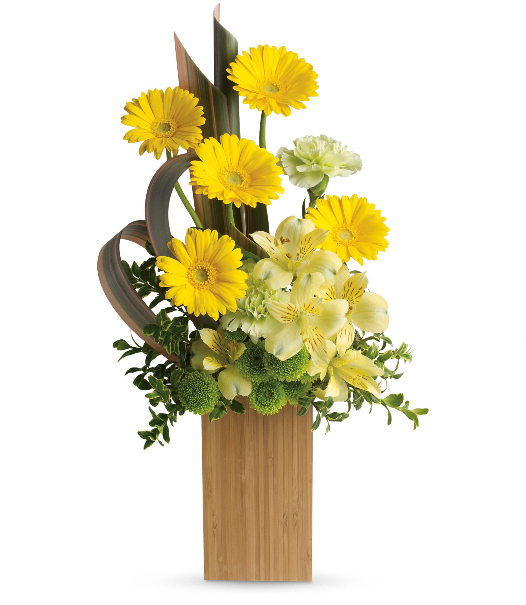 Tall modern arrangement of yellow gerbera daisies and pale blooms in a rectangular bamboo vase