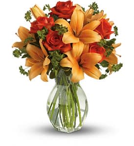 Fiery Lily and Rose - Spark someone's attention by sending this absolutely radiant bouquet. Full of flowers and fiery beauty, it makes a beautiful gift for any occasion.  Features dark orange roses and orange asiatic lilies in a charming glass vase. It's fiery and it's fabulous! Approximately 15" W x 18" H 
