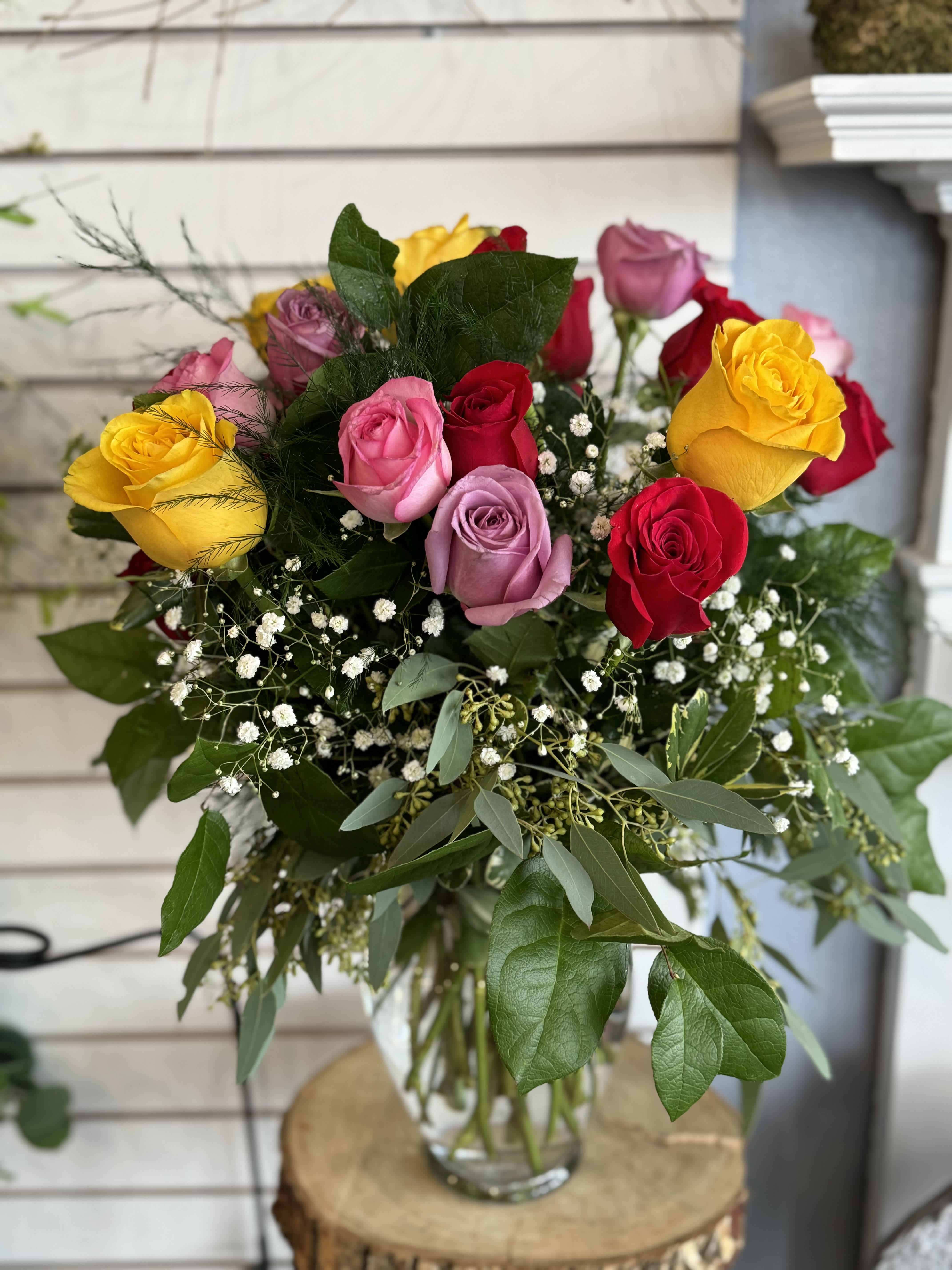 Bouquet of multicolored roses in a glass vase