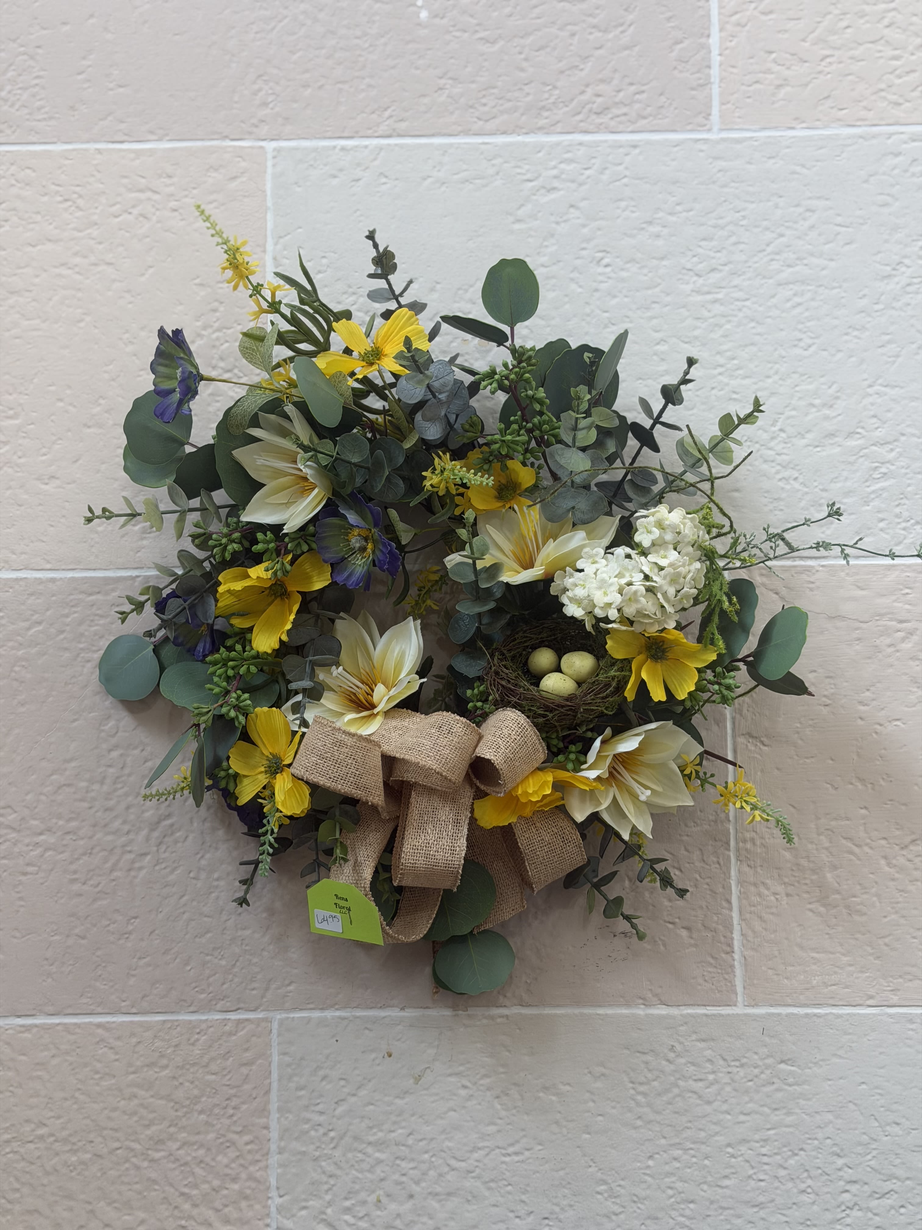 Eucalyptus Wreath  - An artificial eucalyptus wreath with a birds nest and pops of purple and yellow. 