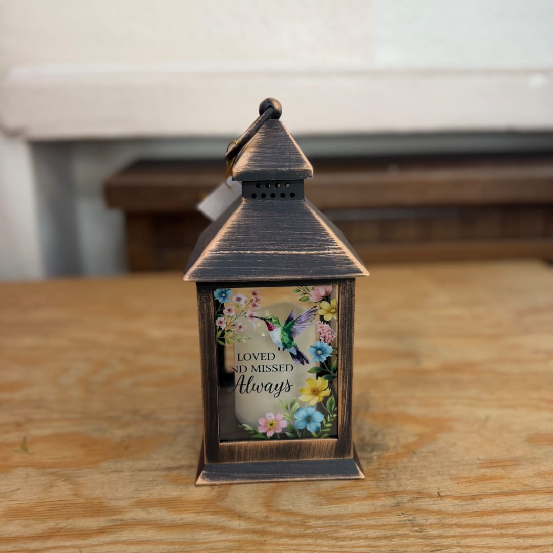 Decorative lantern with a memorial message and floral bird design