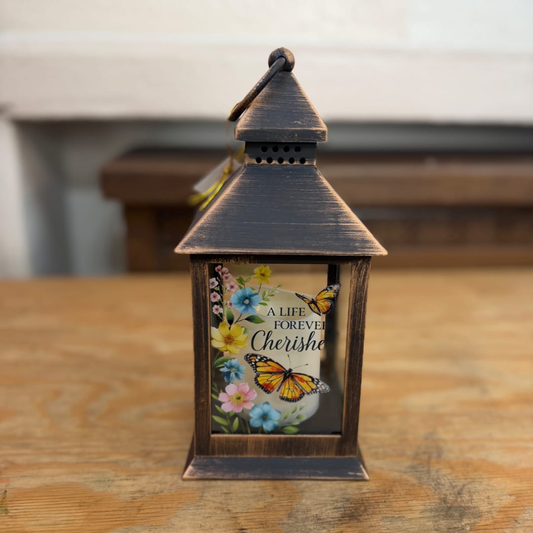 Decorative lantern with a memorial candle and floral butterfly design